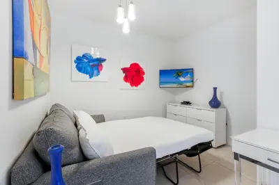 a living room with a couch and a table at Tiffany Ebony - Ocean & Canal views, Walk to Beach in Fort Lauderdale