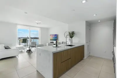 a kitchen and living room with a counter top at Tiffany Ebony - Ocean & Canal views, Walk to Beach in Fort Lauderdale