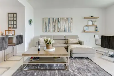 a living room with a couch and a table at Tiffany Coral - 6th FL, Pool, Gym, & Mins to Beach in Fort Lauderdale