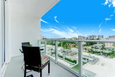 a balcony with a chair and a view of the city at Tiffany Coral - 6th FL, Pool, Gym, & Mins to Beach in Fort Lauderdale