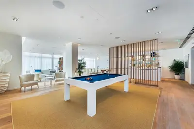 a living room with a pool table in it at Tiffany Coral - 6th FL, Pool, Gym, & Mins to Beach in Fort Lauderdale
