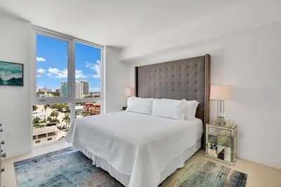 a bedroom with a large bed and a large window at Tiffany Indigo - Rooftop Pool, Gym, Walk to Beach in Fort Lauderdale