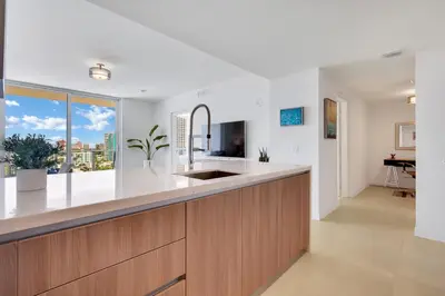 a kitchen with a sink and a large window at Tiffany Indigo - Rooftop Pool, Gym, Walk to Beach in Fort Lauderdale