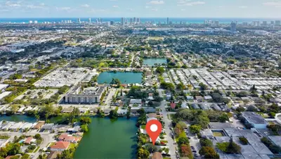 an aerial view of a city with a red marker at Renovated professional design, grill lake view! in Hallandale Beach