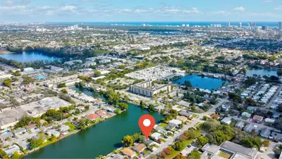 an aerial view of a marina with a red marker at Renovated professional design, grill lake view! in Hallandale Beach