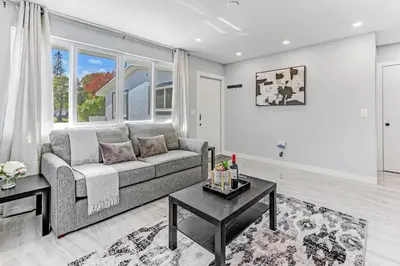 a living room with a couch and a table at Renovated professional design, grill lake view! 1 in Hallandale Beach