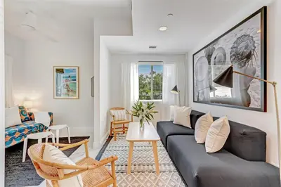 a living room with a black couch and chairs at Artease 2 -Largest, stylish, Peloton bike, near Wynwood Walls & restaurants in Miami