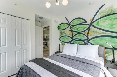 a bedroom with a bed and a painting on the wall at ArTease3 - stylish, near Wynwood Walls & restaurants in Miami