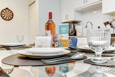 a table with plates and glasses and a bottle of wine at ArTease4 - stylish, near Wynwood Walls & restaurants in Miami