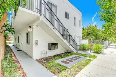 a white building with a staircase on the side of it at ArTease4 - stylish, near Wynwood Walls & restaurants in Miami