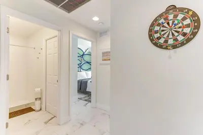 a dart board hanging on a wall in a hallway at ArTease4 - stylish, near Wynwood Walls & restaurants in Miami