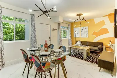 a dining room and living room with a table and chairs at ArTease4 - stylish, near Wynwood Walls & restaurants in Miami
