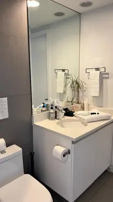 a bathroom with a sink and a mirror and a toilet at Monte Carlo Suites in Miami Beach in Miami Beach