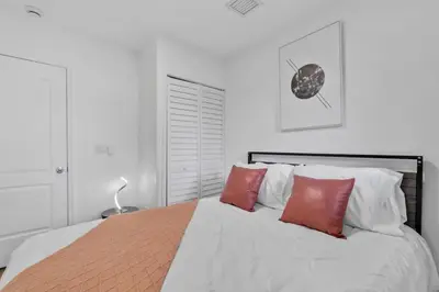 a bedroom with a bed with red pillows on it at Escape to Private Poolside Bliss in Hollywood