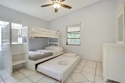 a bedroom with two bunk beds and a ceiling fan at 4 Mi to Beach Hollywood Home with Patios! in Hollywood