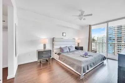 a white bedroom with a bed and a television at Modern 1 Bed in the Heart of Brickell With Free Parking in Miami