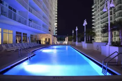 a large swimming pool in a building at night at Modern 1 Bed in the Heart of Brickell With Free Parking in Miami