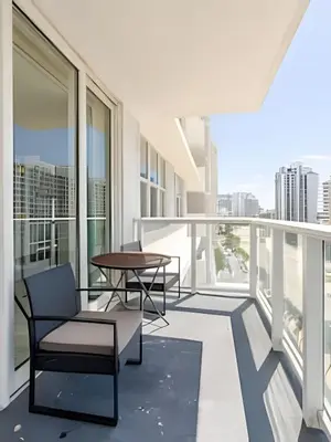 a balcony with chairs and a table on a building at Pavilion - Stunning bay view in Miami Beach