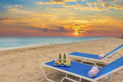 a picnic table on the beach with bottles of beer at Hot Tub - Hollywood Beach Boardwalk - Amazing Pool in Hollywood
