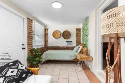 a bedroom with a bed and a window at 3BR Boho Style Home w Private yard & Firepit in Miami