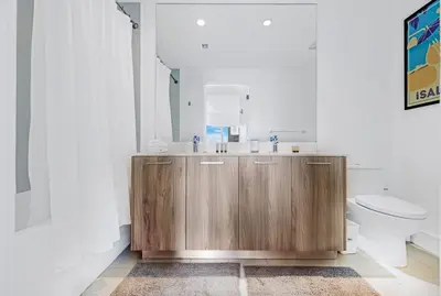 a bathroom with a wooden sink and a toilet at Exclusive High-Rise Edgewater 1BD - Tennis & Sauna in Miami