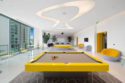 a billiard room with a yellow pool table at Exclusive High-Rise Edgewater 1BD - Tennis & Sauna in Miami