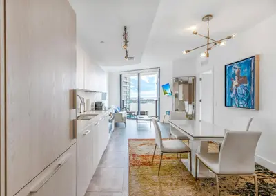 a kitchen and dining room with a table and chairs at Exclusive High-Rise Edgewater 1BD - Tennis & Sauna in Miami
