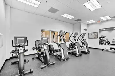 a gym with a row of exercise bikes in it at 36th floor Brickell bay view 1BR 2 Queens and Sofa Bed in Miami
