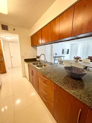 a kitchen with a sink and a counter top at 36th floor Brickell bay view 1BR 2 Queens and Sofa Bed in Miami