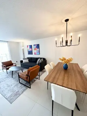 a living room with a table and a couch at 36th floor Brickell bay view 1BR 2 Queens and Sofa Bed in Miami
