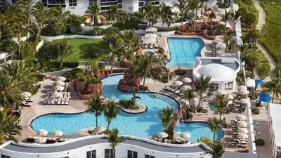 an aerial view of a resort with a swimming pool at Luxurious Beach Resort Balcony in Sunny Isles Beach