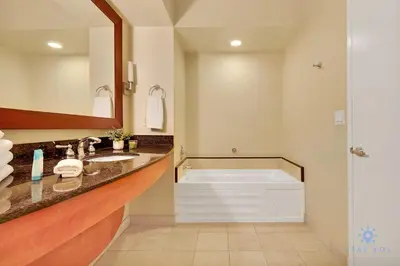 a bathroom with a tub and a sink and a mirror at Luxurious Beach Resort Balcony in Sunny Isles Beach