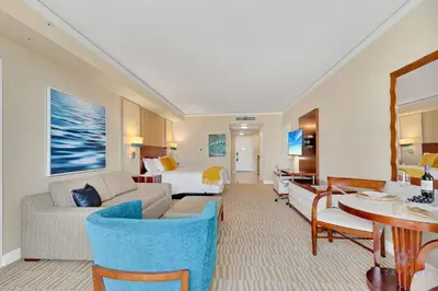 a living room with a couch and a bed and a table at Luxurious Beach Resort Balcony in Sunny Isles Beach