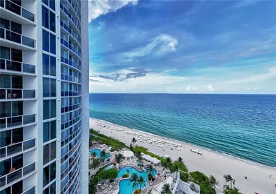 a view of the beach and the ocean from a building at Luxurious Beach Resort Balcony in Sunny Isles Beach