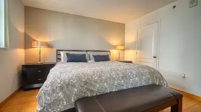 a bedroom with a large bed and two lamps at Beautiful Brickell Miami apt 2BR/2BA + Parking in Miami