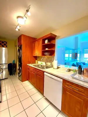 a large kitchen with a sink and a dishwasher at Large beautiful penthouse ocean front with beach access and free parking in Miami Beach in Miami Beach