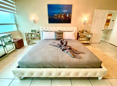 a bedroom with a large bed with a ribbon on it at Large beautiful penthouse ocean front with beach access and free parking in Miami Beach in Miami Beach