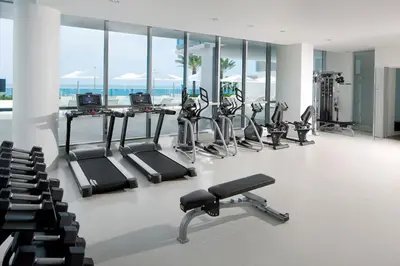 a gym with several treadmills and cardio machines at Ocean 2 Sky at Monte Carlo Miami Beach in Miami Beach