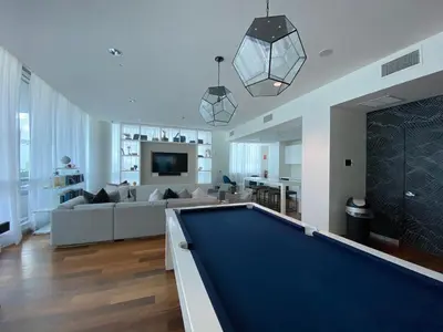a living room with a pool table in it at Ocean 2 Sky at Monte Carlo Miami Beach in Miami Beach