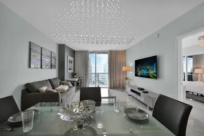a living room with a dining table and a couch at Perfect One Bedroom at Icon Brickell Amazing views in Miami