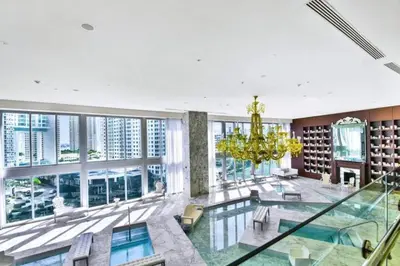 a large room with a pool and a chandelier at Perfect One Bedroom at Icon Brickell Amazing views in Miami