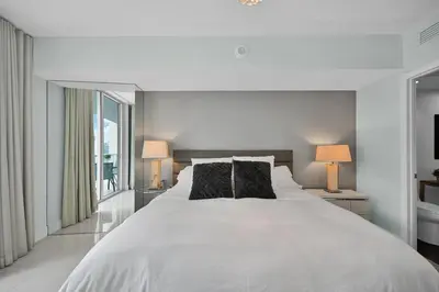 a bedroom with a large white bed with two lamps at Perfect One Bedroom at Icon Brickell Amazing views in Miami