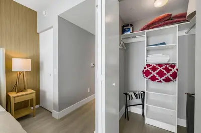a bedroom with a closet with a bed and a chair at Elegant Beachfront Condo Offering Stunning Views in Hollywood