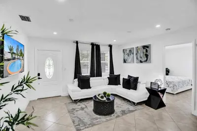 a living room with two white couches and a bed at Cozy Fun House 4 2 Aventura Stadium Beach in North Miami Beach