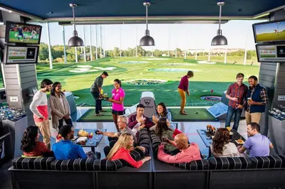 a group of people sitting in a room with a golf course mural at Smart Tiny House Garden in Miami Gardens