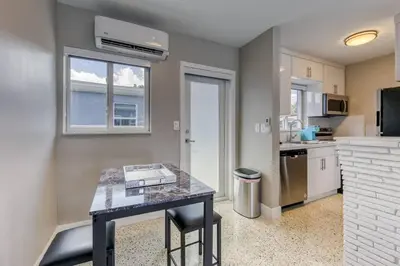 a kitchen with a counter and a table in a room at Sunshine Manor 2017-2 in Fort Lauderdale