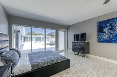 a bedroom with a bed and a flat screen tv at Sunshine Manor 2017-2 in Fort Lauderdale