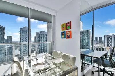 a dining room with a view of the city at Amazing 2 Bedroom at Icon in the Heart of Brickell in Miami
