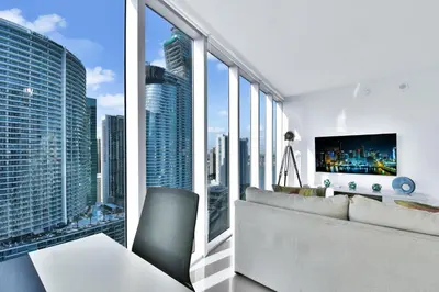 a living room with a couch and a large window at Amazing 2 Bedroom at Icon in the Heart of Brickell in Miami