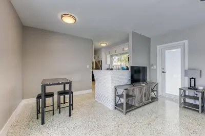 a living room with two stools and a table at Sunshine Manors 2017-3 in Fort Lauderdale
